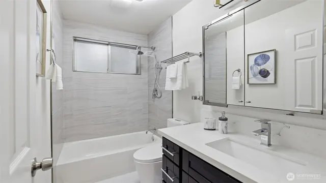 a bathroom with a sink toilet tub and shower