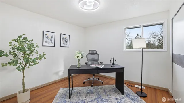 a workspace with furniture and a potted plant