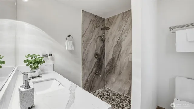 a bath room with a sink and a shower