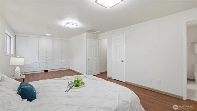 a bedroom with a bed and a large window