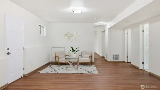 a living room with furniture and wooden floor