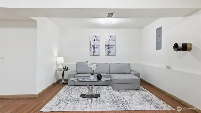 a living room with furniture and wooden floor