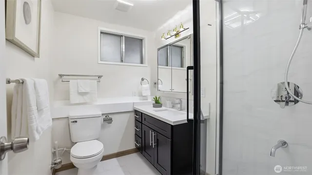 a bathroom with a sink toilet and shower