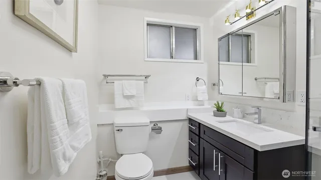 a bathroom with a sink toilet and mirror