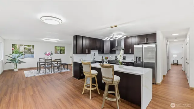 a large kitchen with a table and chairs in it