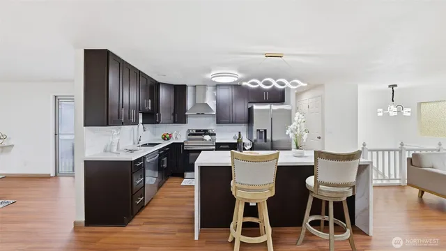 a large kitchen with a table and chairs
