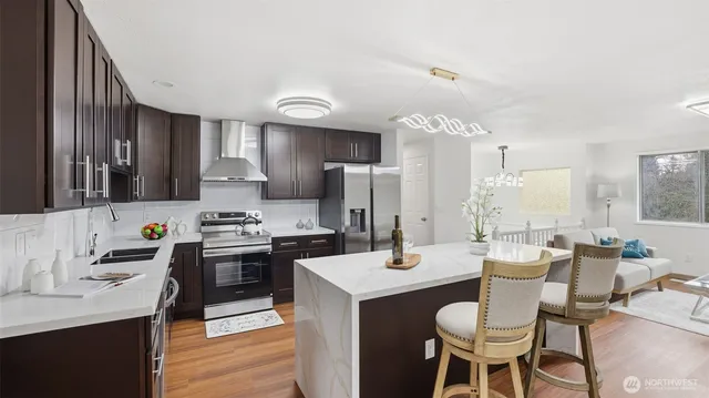 a kitchen with a table chairs stove and cabinets