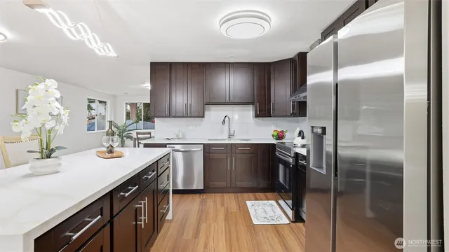 a kitchen with a sink stainless steel appliances and cabinets