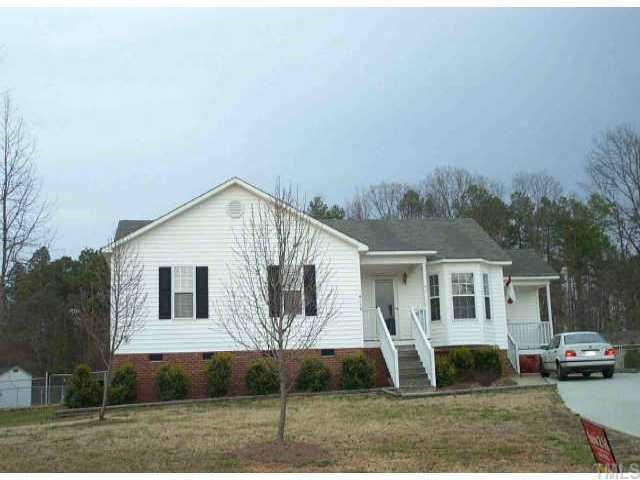 4113 Rockside Hills Drive Raleigh, NC 27603 - Photo 1 of 1 a view of a white house next to a yard