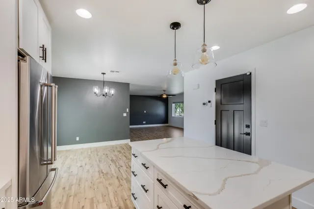 a view of a kitchen with wooden floor and a refrigerator