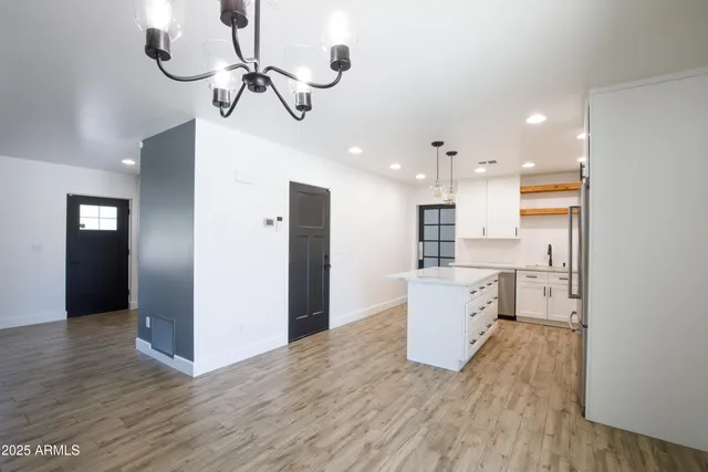 a kitchen with refrigerator and cabinets