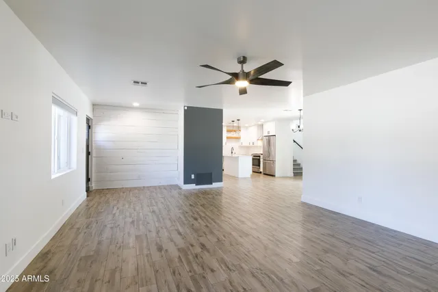 a view of empty room with wooden floor