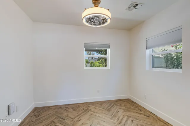 a view of an empty room with a fireplace and a window