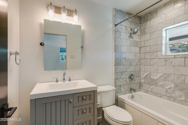 a view of empty room with windows and fireplace