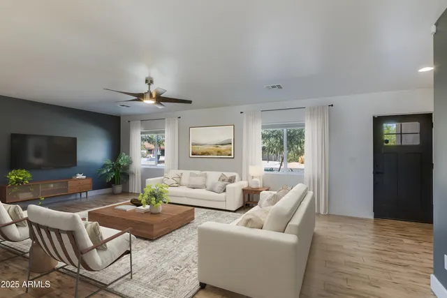 a living room with furniture and a flat screen tv