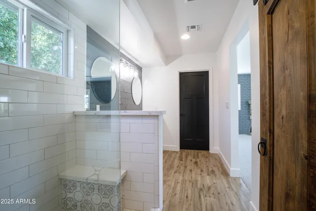 a view of a livingroom with a ceiling fan and window