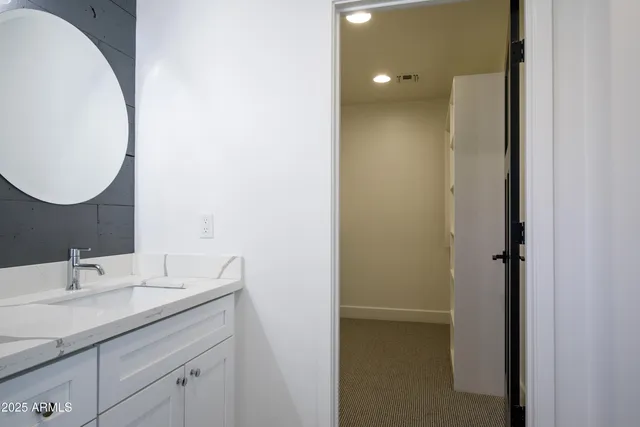 a view of a big room with a floor to ceiling window and a ceiling fan