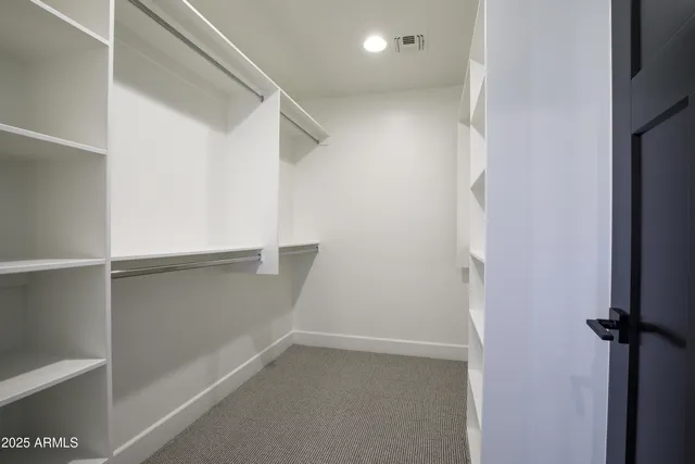 a bathroom with a granite countertop toilet and a sink