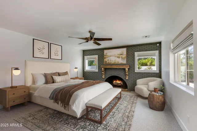 a living room with furniture a flat screen tv and a large window