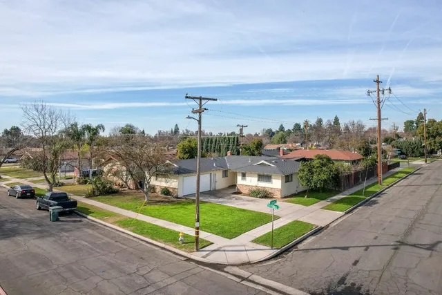a view of a terrace with a garden and bench
