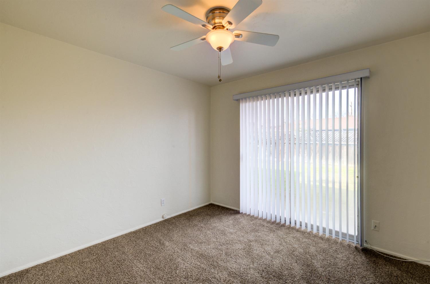 3955 North Tollhouse Road Fresno, CA 93726 - Photo 11 of 17 an empty room with a window and a fan