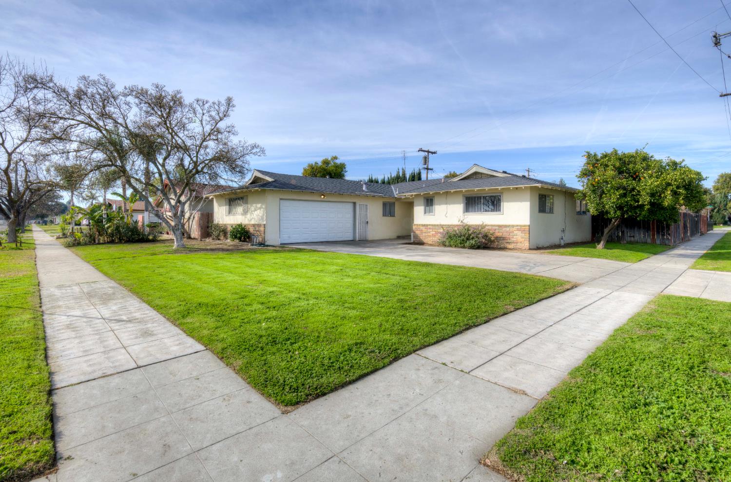 3955 North Tollhouse Road Fresno, CA 93726 - Photo 16 of 17 a view of a house with a yard and pathway