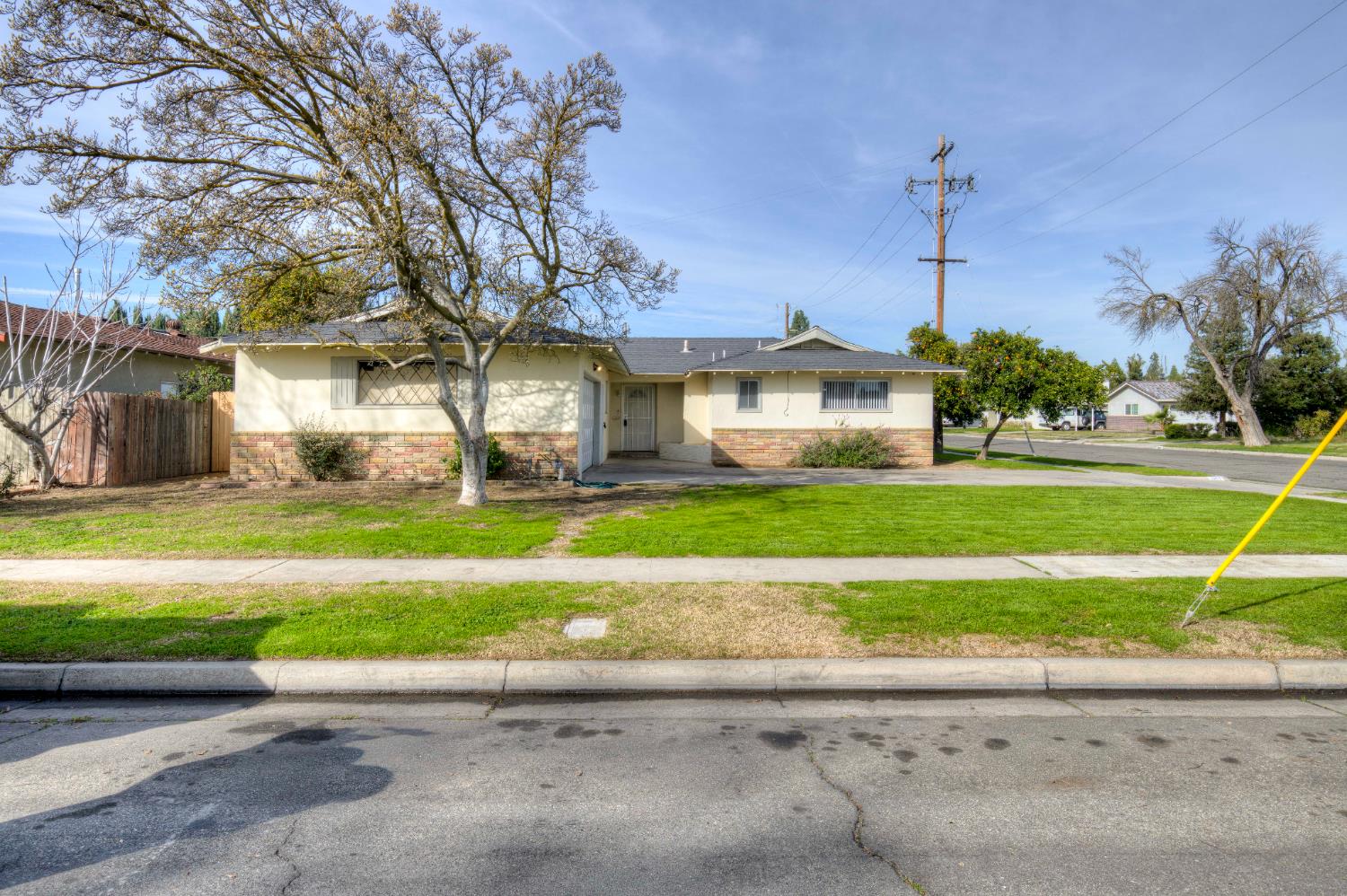 3955 North Tollhouse Road Fresno, CA 93726 - Photo 4 of 17 a front view of a house with a yard and potted plants