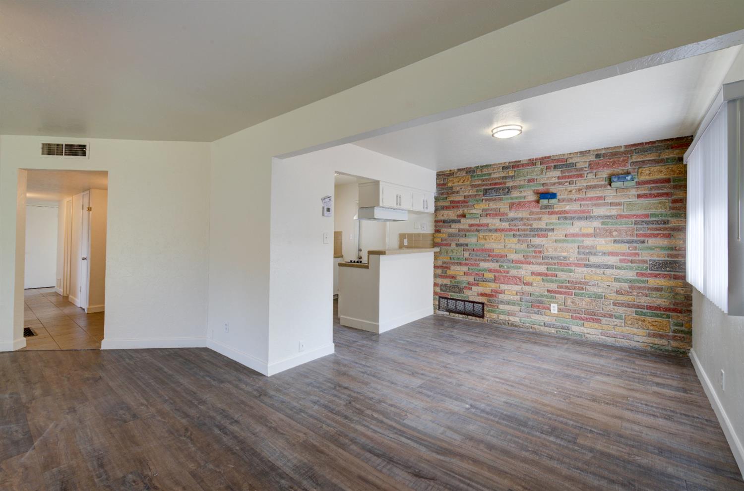 3955 North Tollhouse Road Fresno, CA 93726 - Photo 6 of 17 a view of empty room with wooden floor