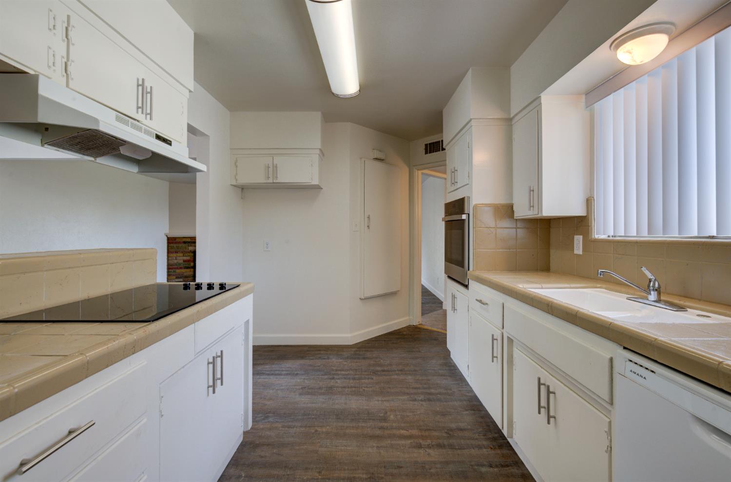 3955 North Tollhouse Road Fresno, CA 93726 - Photo 8 of 17 a kitchen with granite countertop a sink and cabinets