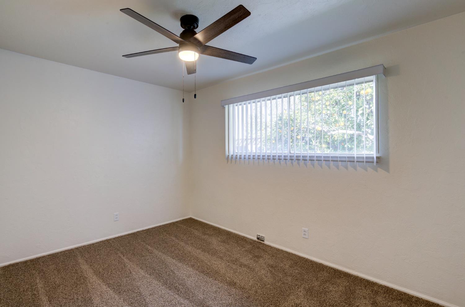 3955 North Tollhouse Road Fresno, CA 93726 - Photo 10 of 17 an empty room with a window and a fan