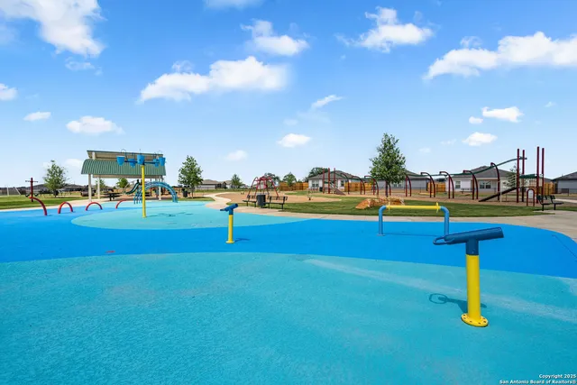 a swimming pool with outdoor seating and yard in back