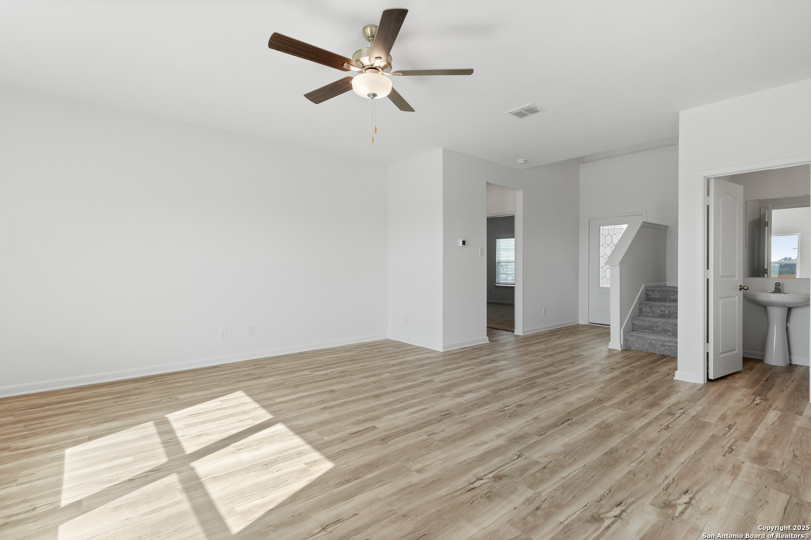 16020 Stratford Cove Lytle, TX 78052 - Photo 8 of 29 a view of empty room with wooden floor and fan