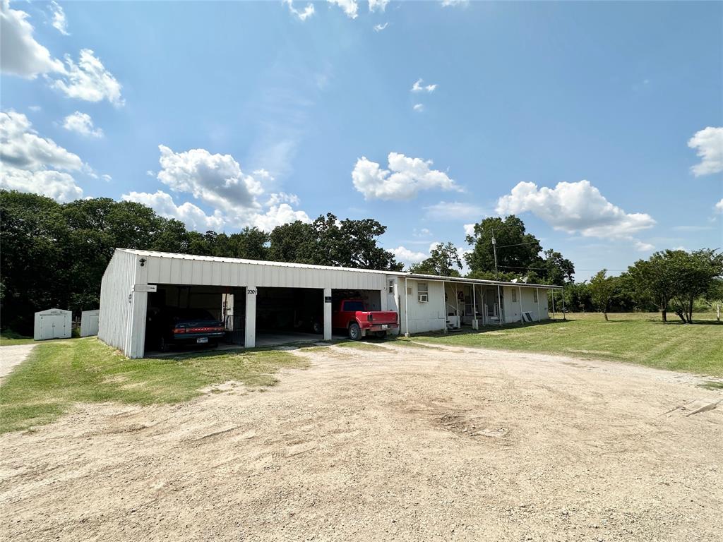 a view of a house with a yard and garage