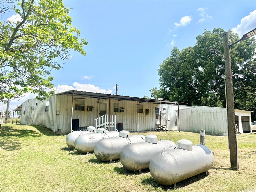 3210 Rural Ranch Road, Unit 14 Gainesville, TX 76240 - Photo 12 of 19 a view of a backyard with table and chairs and wooden fence