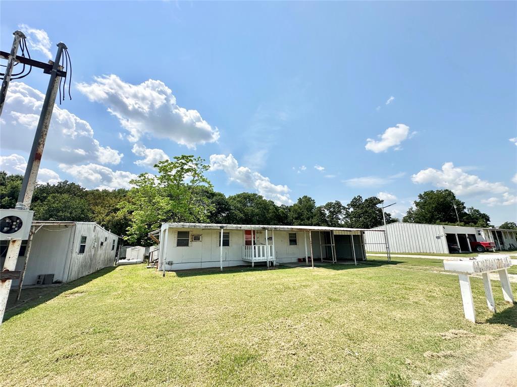 3210 Rural Ranch Road, Unit 14 Gainesville, TX 76240 - Photo 17 of 19 a front view of a house with a yard