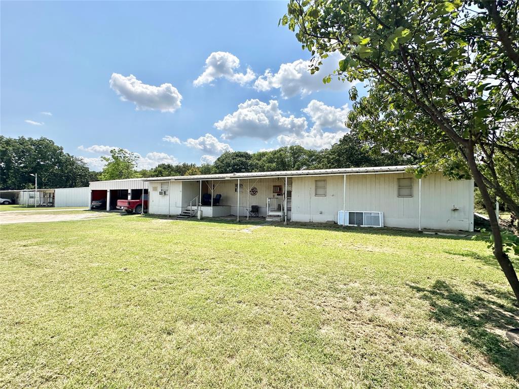3210 Rural Ranch Road, Unit 14 Gainesville, TX 76240 - Photo 4 of 19 a view of a house with a backyard