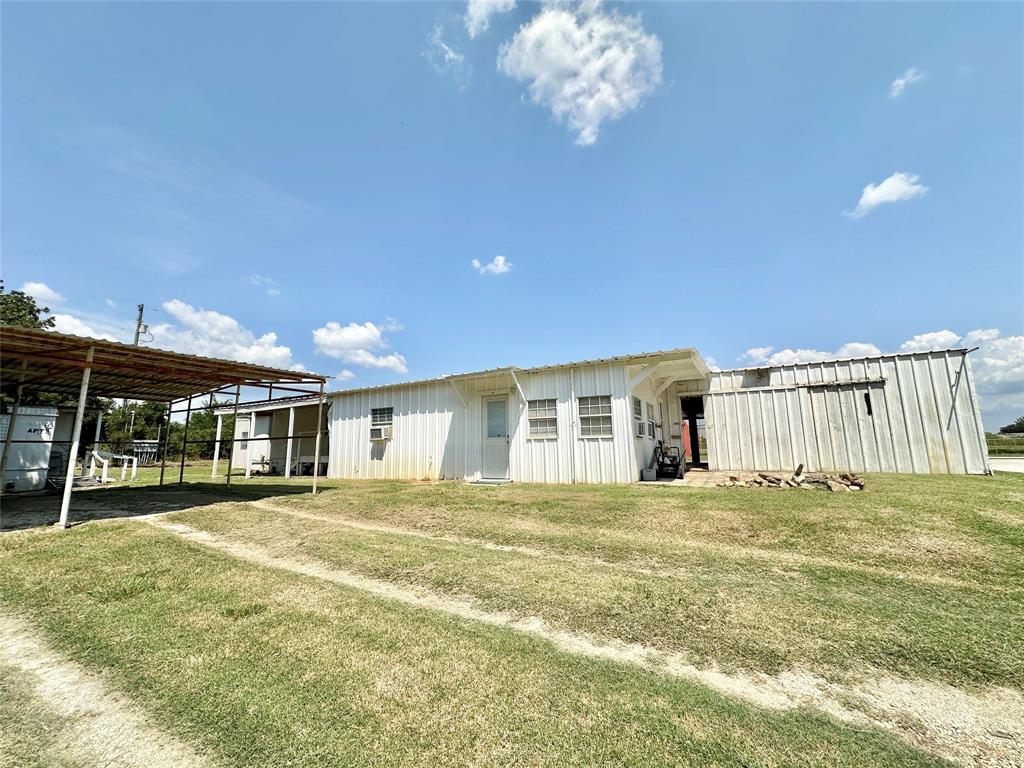 3210 Rural Ranch Road, Unit 14 Gainesville, TX 76240 - Photo 8 of 19 a view of a house with a big yard and large trees