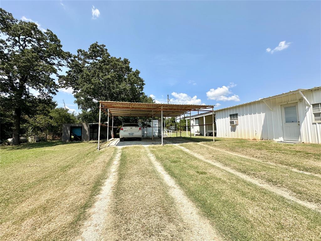 3210 Rural Ranch Road, Unit 14 Gainesville, TX 76240 - Photo 9 of 19 a front view of a house with a yard and garage