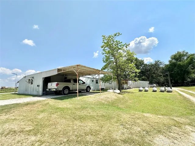a view of a swimming pool and trees in front of it