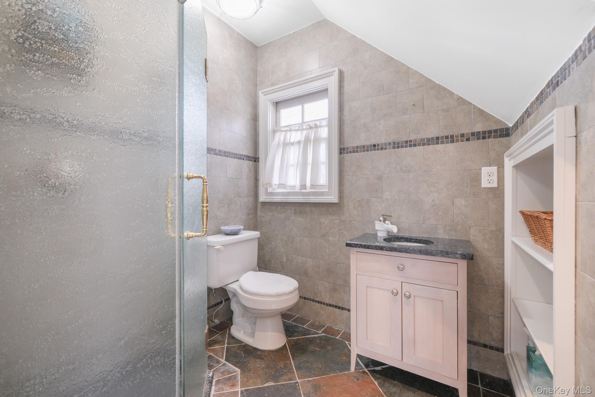 320 Illington Road Ossining, NY 10562 - Photo 27 of 42 a bathroom with a granite countertop toilet a sink and a window