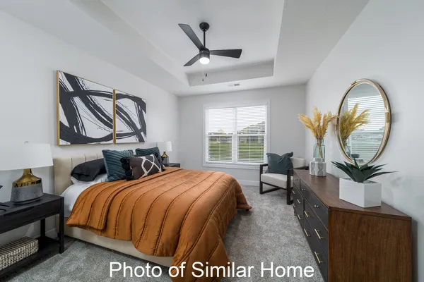 a bed room with a bed and a chair