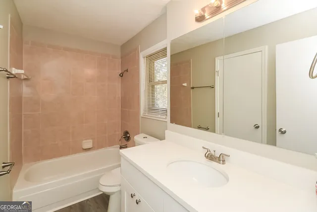 a bathroom with a tub sink and mirror