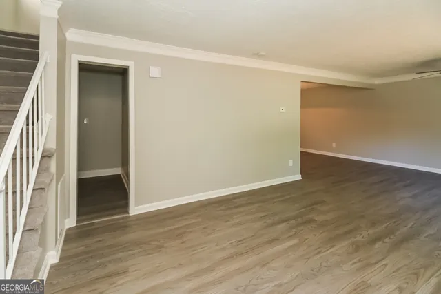 an empty room with wooden floor and a window
