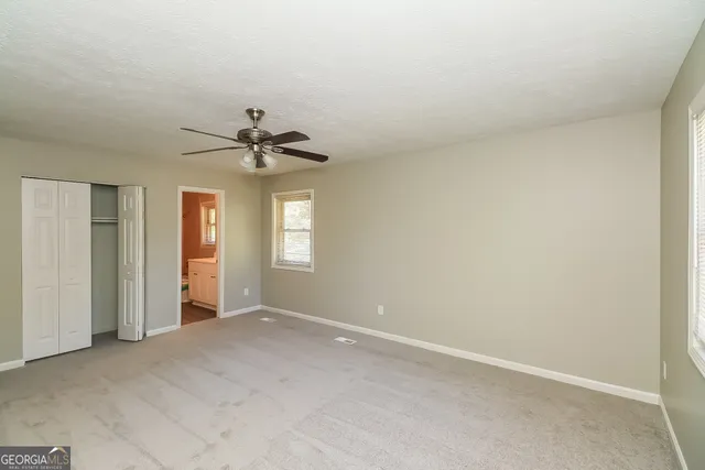 a view of a livingroom with a ceiling fan and window