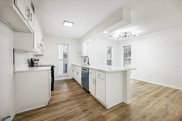 a kitchen with cabinets a sink and appliances