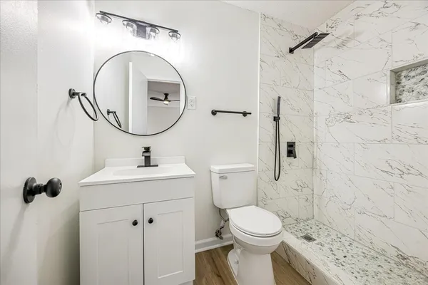a bathroom with a sink toilet and shower