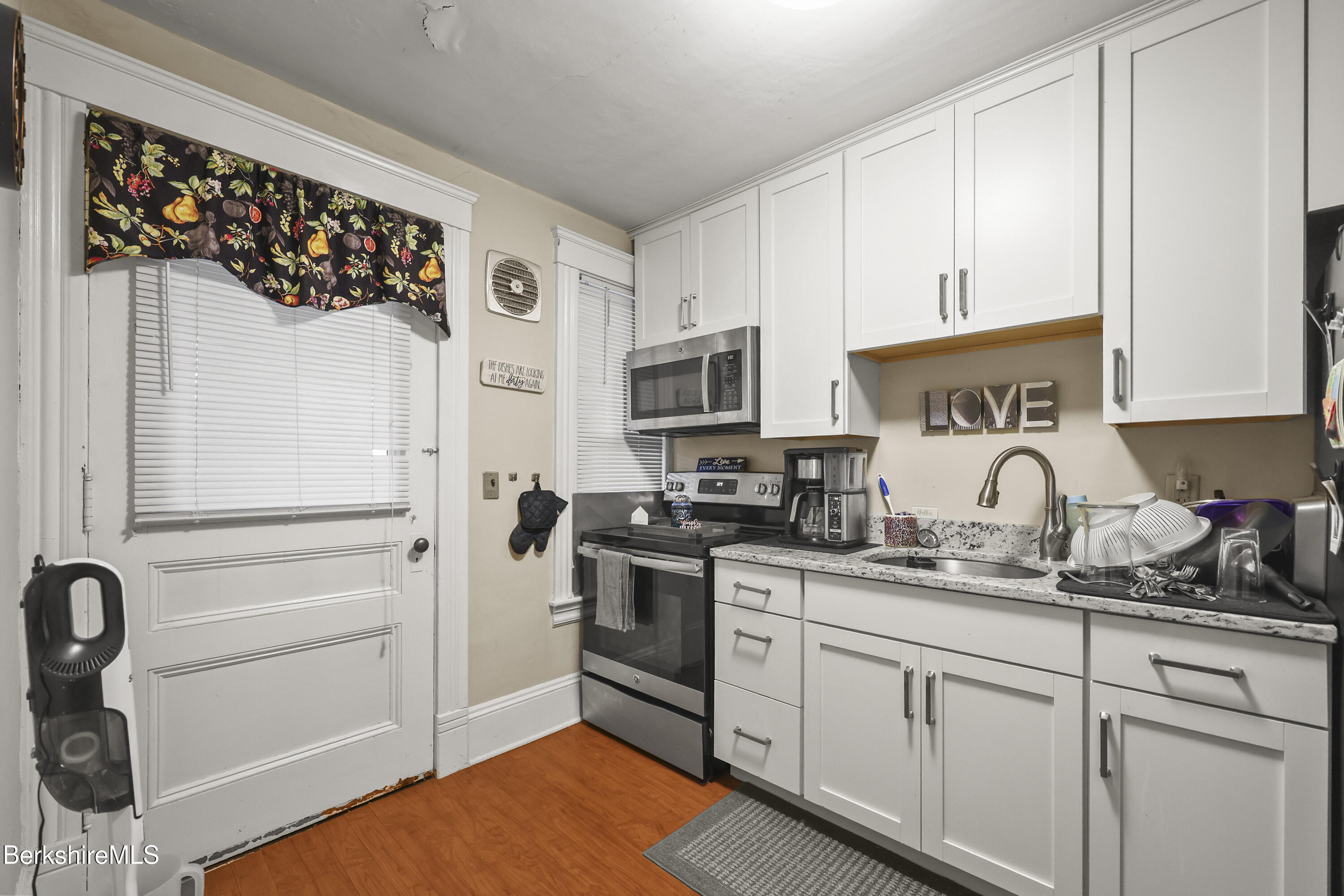 3-5 Melrose Street Adams, MA 01220 - Photo 13 of 37 a kitchen with stainless steel appliances granite countertop a refrigerator sink and cabinets