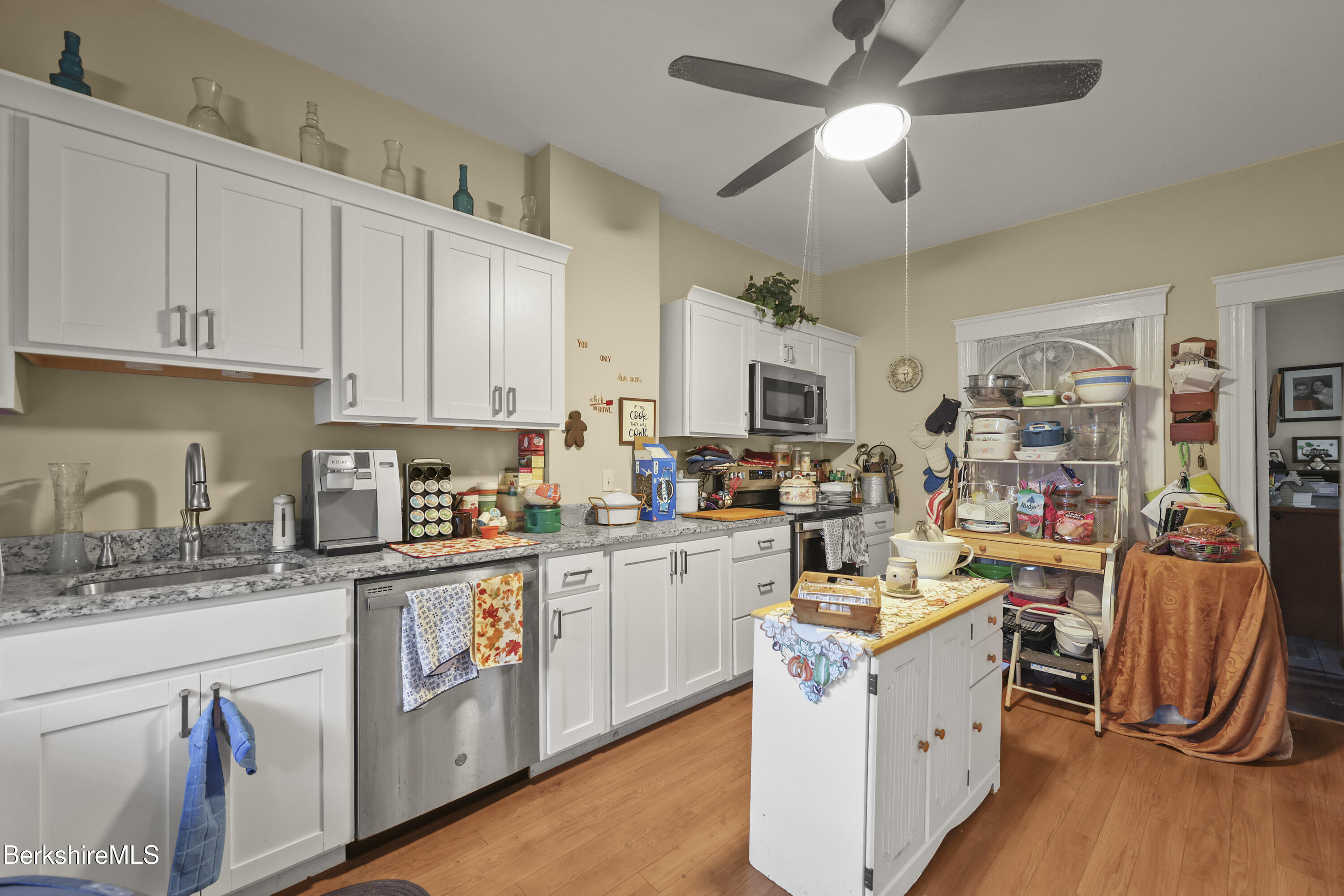 3-5 Melrose Street Adams, MA 01220 - Photo 16 of 37 a kitchen with stainless steel appliances granite countertop a refrigerator a stove top oven a sink dishwasher and white cabinets with wooden floor