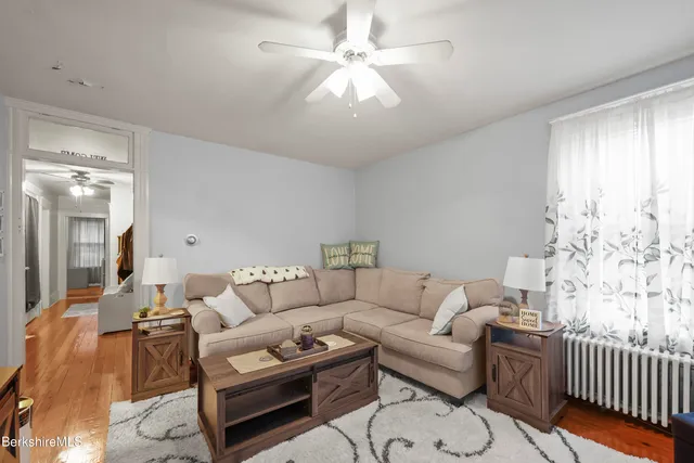 a living room with furniture and a chandelier