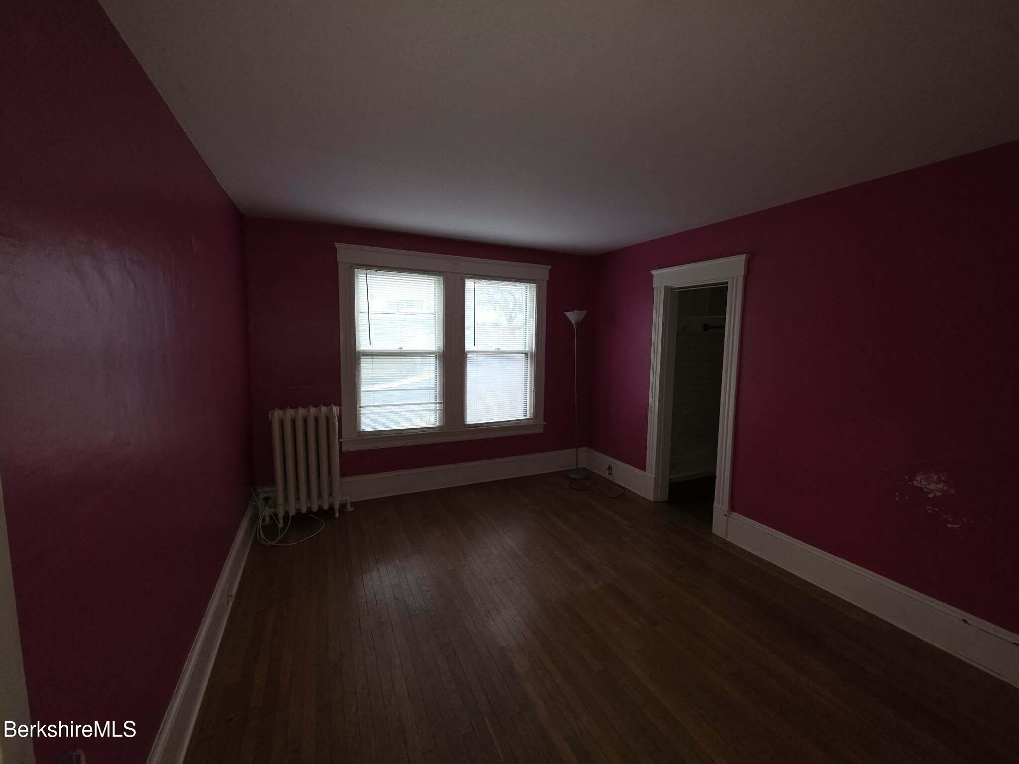 3-5 Melrose Street Adams, MA 01220 - Photo 27 of 37 an empty room with wooden floor and windows